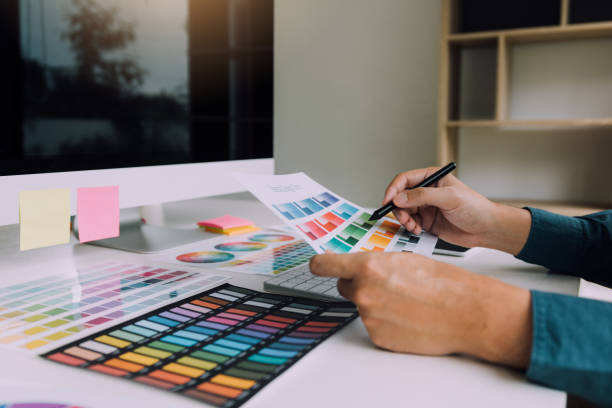 istock Hand designer choosing colors for doing graphic on laptop. 1140154515