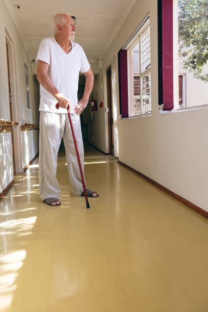 istock Senior male patient standing with stick 1140154529