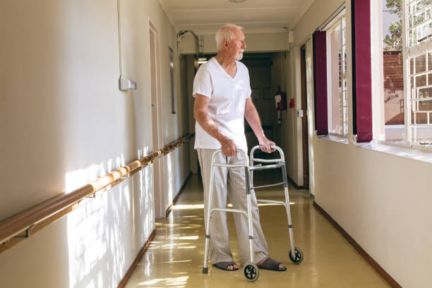 istock Senior male patient standing with walker 1140154540