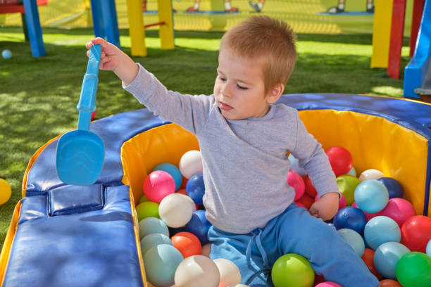 istock Little boy playing with colorful balls 1140155553