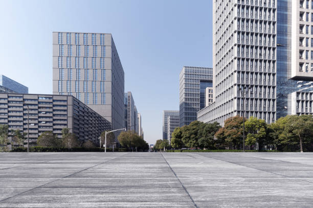 istock Modern business office buildings with empty road, empty concrete square floor 1140155582