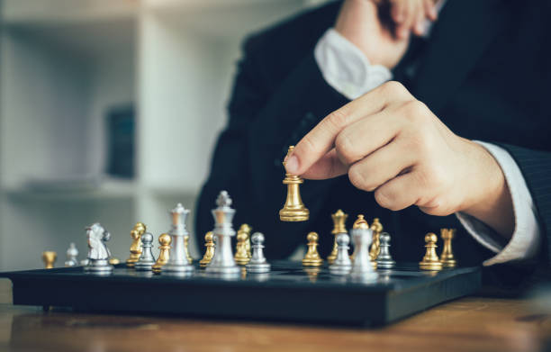 istock Businessman playing chess game beat opponent with strategy concept. 1140155613