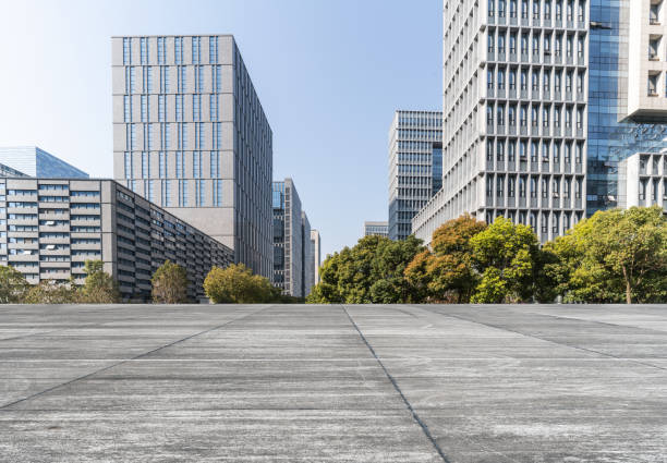 istock Modern business office buildings with empty road, empty concrete square floor 1140155723