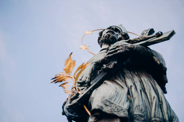 Statue of John of Nepomuk at Charles bridge in the morning. Vertical. Prague, Czech Republic stock photo