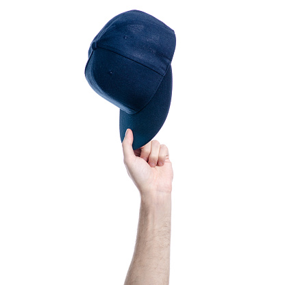 Blue cap in hand on white background isolation