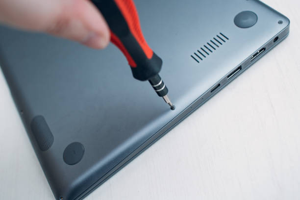istock Disassembly and repair laptop. Service, replacement cooling system, fan cooler and thermal paste. Screwdriver, bolts, screws. 1140157771