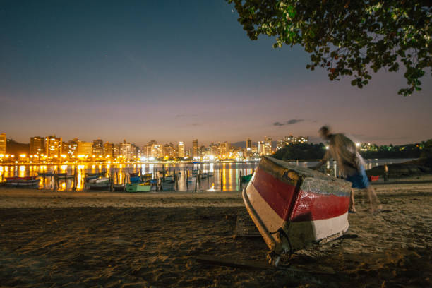 This beatiful shot show the sun setting while boats float at Vitória - ES Brazil