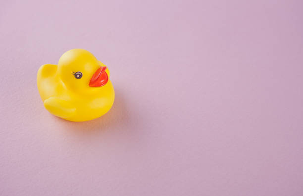 istock yellow rubber duck on the pink background 1140161166