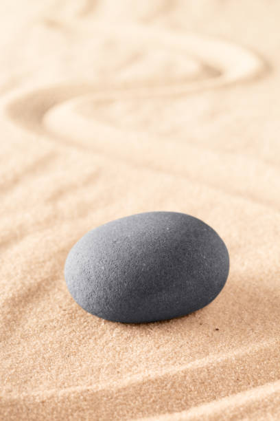 istock round stone on sand with line 1140161423