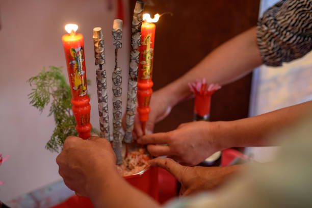 istock Elderly lights up traditional candles for wedding ceremony 1140161520