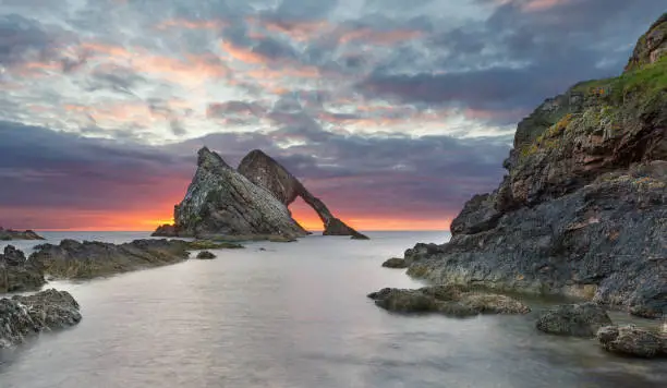 Photo of Bow-fidle Rock sunrise landscape on the coast of Scotland on a cloudy morning