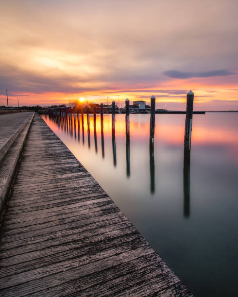 istock Sunset over an empty fishing pier and boat basin. 1140165448