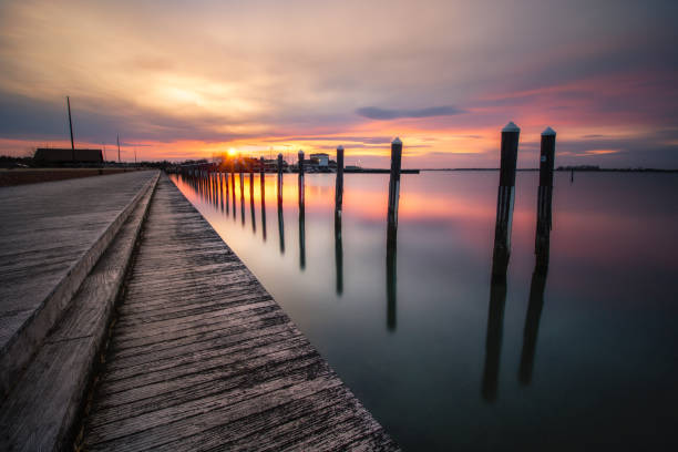 istock Sunset over an empty fishing pier and boat basin. 1140165449
