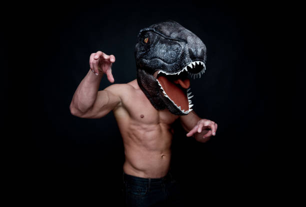 istock Sexy muscular man wearing a dinosaur mask 1140165879