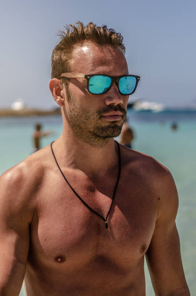 istock Shirtless man enjoying the beach 1140167497