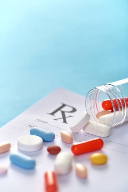 istock Many pills and tablets on blue background for medicine concept 1140170190