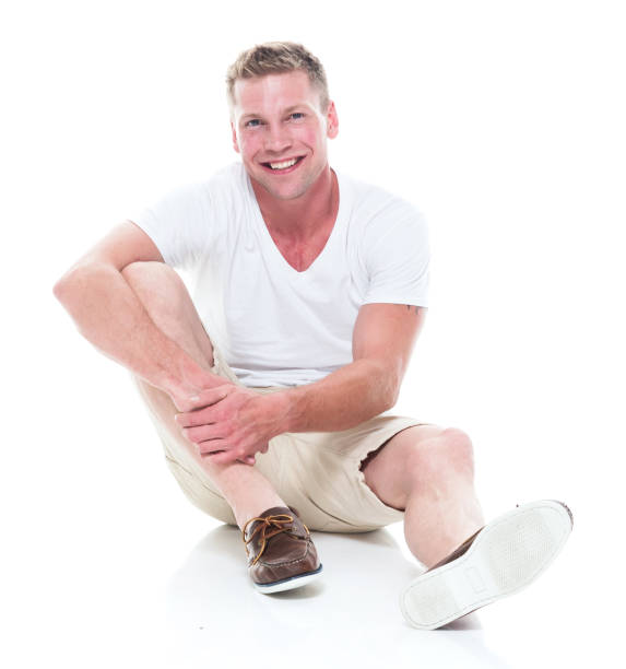 istock Handsome man in shirt and shorts is seated and relaxed 1140170621