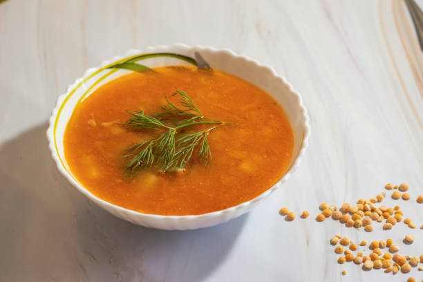 istock Veggie pea soup with carrots and dill on a white background 1140171265