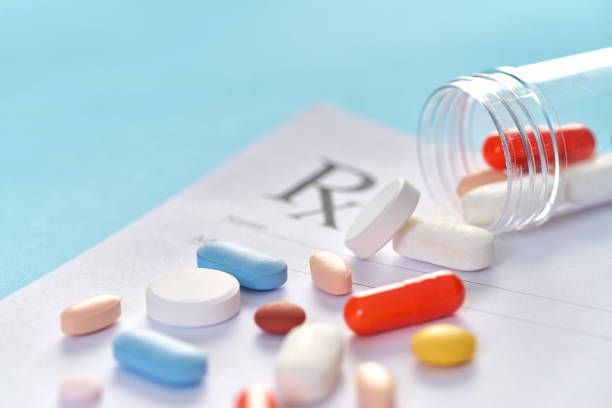 istock Many pills and tablets on blue background for medicine concept 1140171924