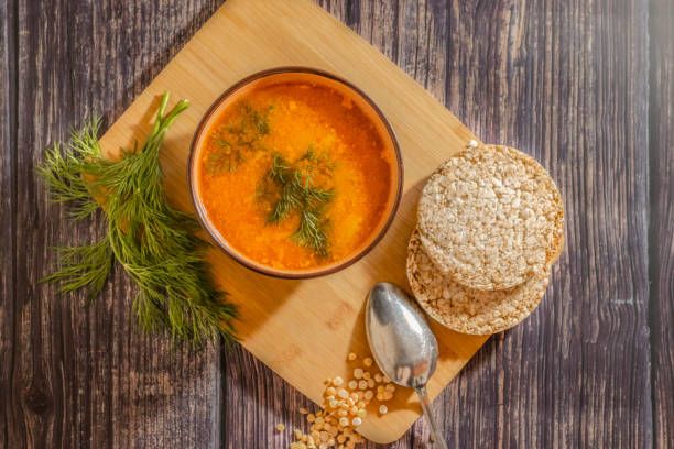 Vegan pea soup with dill and bread on a dark background