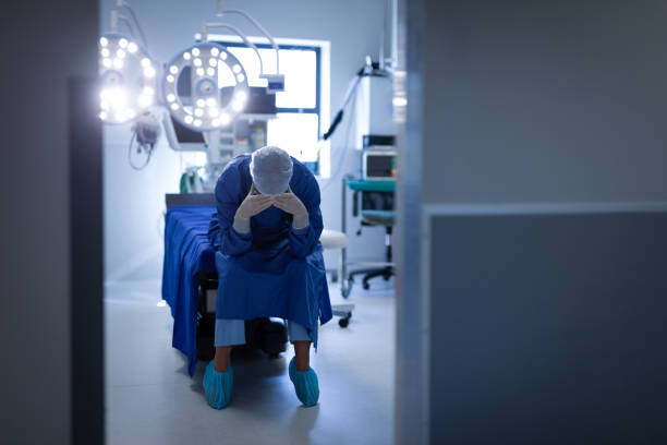 istock Upset female surgeon sitting on bed in operation room 1140173193