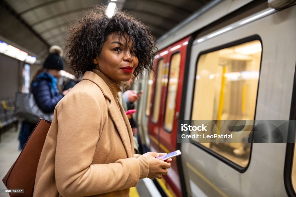 Woman waiting for the subway train Commuter Stock Photo