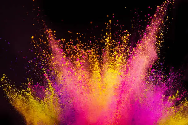 Photo of Colored powder explosion on black background.