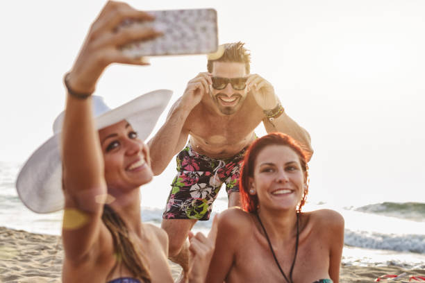 istock Friends at sea: relaxing on the beach at sunset 1140182139