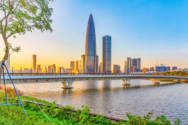Shenzhen Talent Park at sunset View of the Shenzhen Talent Park China Resources Headquarters skyscraper and lake during sunset on October 30, 2018 in Shenzhen shenzhen technology stock pictures, royalty-free photos & images