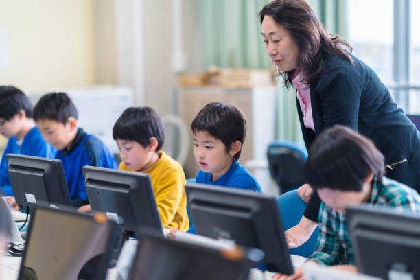 istock Group of elementary school children learning to use computer at school 1140184952