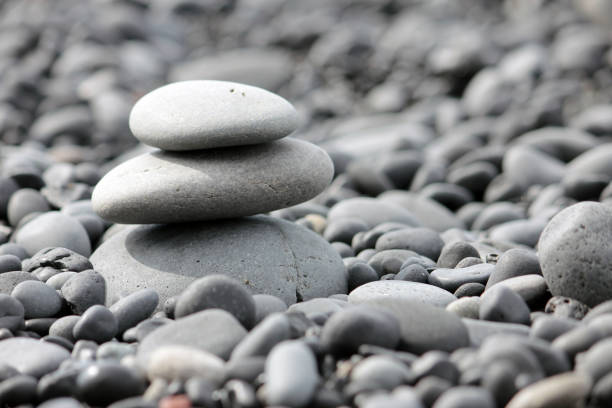 Small tower made of pebbles on a rocky beach.