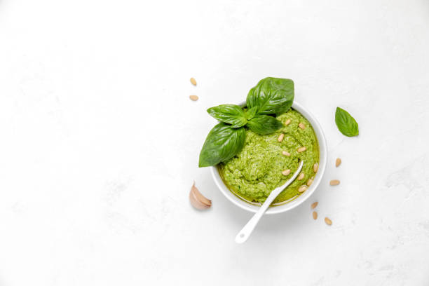 Pesto in white bowl, view from above, blank space for a text