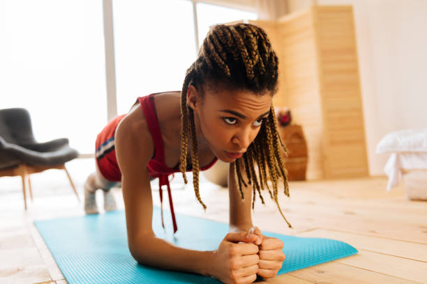 istock Dark-eyed woman feeling exhausted while finishing workout with plank 1140193138