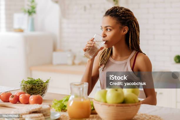 Slim And Fit Woman Drinking Water Before Having Breakfast Stock Photo - Download Image Now