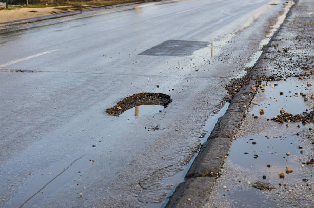 istock Big pothole on road after winter 1140194074