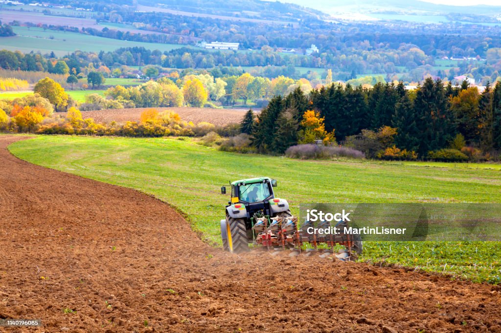 Tractor plowing the field . Tractor plowing the field . Autumn landscape. Plowing Stock Photo