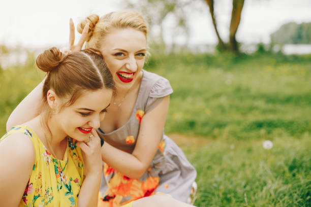 istock Two pretty girls in a summer park 1140196180
