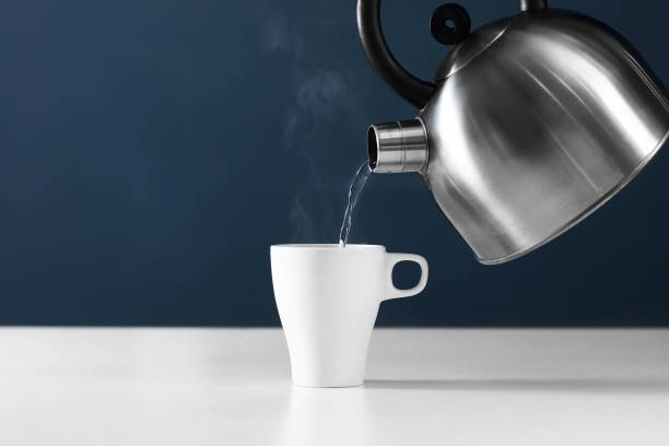 https://media.istockphoto.com/id/1140199504/photo/retro-kettle-pouring-water-into-a-cup-on-a-white-background-with-smoke-on-wood-table.jpg?s=612x612&w=0&k=20&c=5pq18RyCUwt25YnyJ4_3sd75edO3zMGYle94nJgTe68=