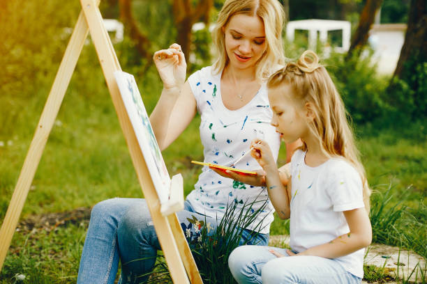 istock Mother with daughter drawing in a park 1140199954