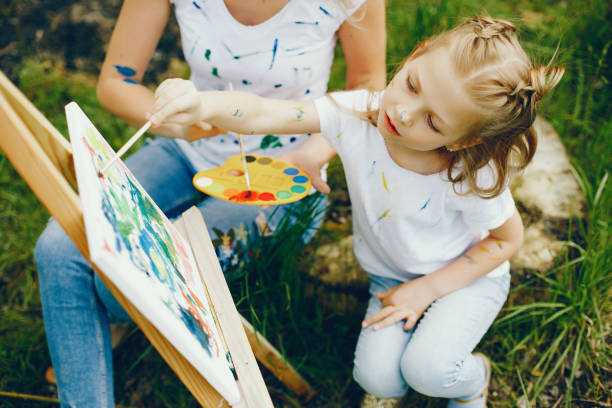 istock Mother with daughter drawing in a park 1140200006