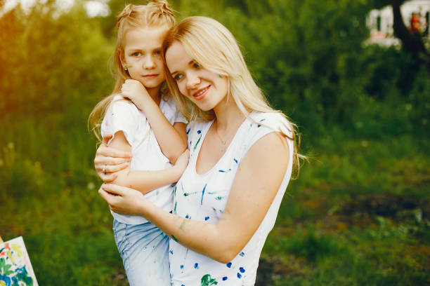 istock Mother with daughter drawing in a park 1140200219