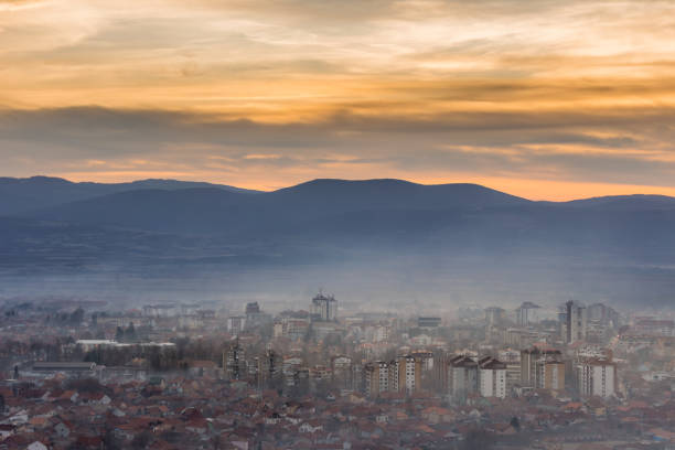 Photo of Golden hour view of misty Pirot cityscape