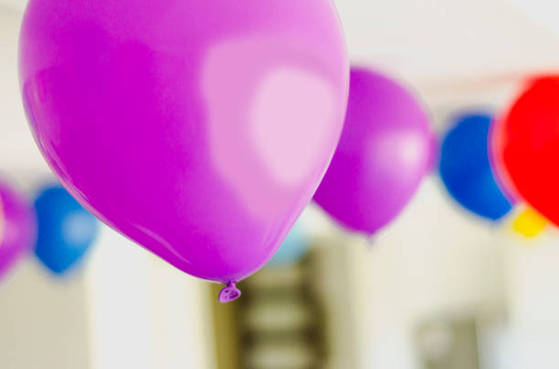 A background of pink and purple balloons.