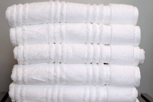 istock Neatly stacked pile of folded white towels 1140202381