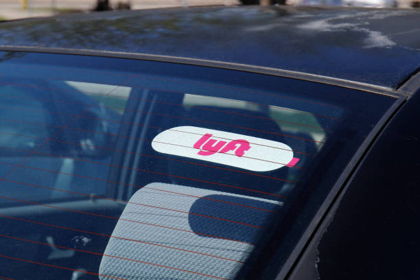 car for hire with a lyft sticker. lyft and uber have replaced many taxi cabs for transportation with a smart phone app i - have imagens e fotografias de stock