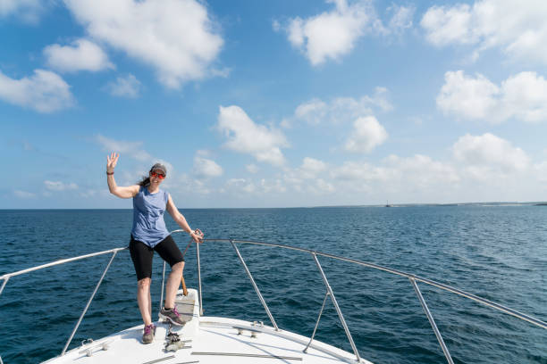 istock Mature woman standing on the boat 1140206577