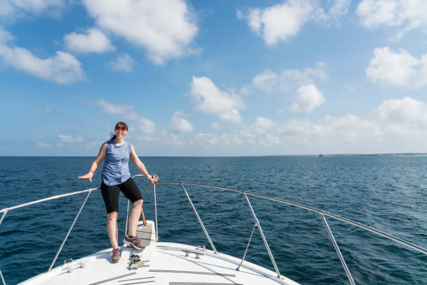 istock Mature woman standing on the boat 1140206593