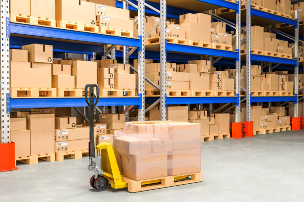 istock Pallet jack with cardboard boxes in storehouse, 3D rendering 1140206743