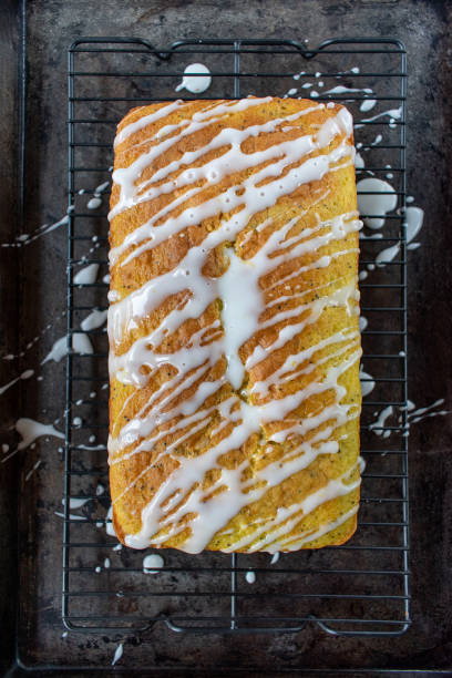 baked lemon poppy seed cake loaf with white icing drizzle