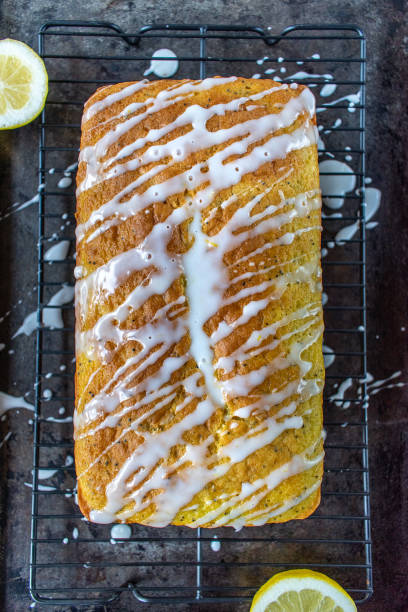 istock baked lemon poppy seed cake loaf with white icing drizzle 1140207710